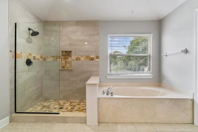 a bathroom with a bathtub and shower