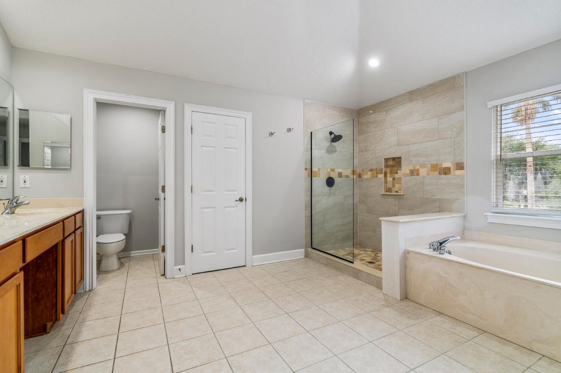206 2nd Street St. Augustine, FL 32084 - Photo 19 of 32 a spacious bathroom with a granite countertop sink a toilet and shower