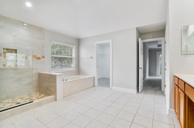 a spacious bathroom with a bathtub and a shower