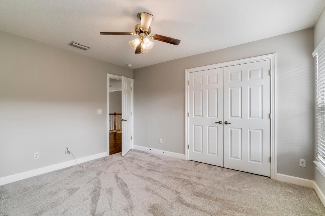 206 2nd Street St. Augustine, FL 32084 - Photo 23 of 32 an empty room with a chandelier fan and windows
