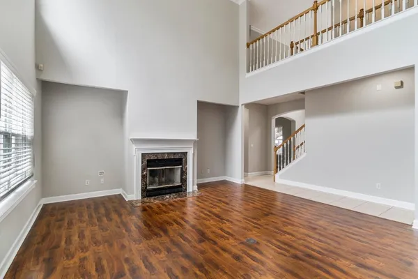 a view of a livingroom with wooden floor and a fireplace