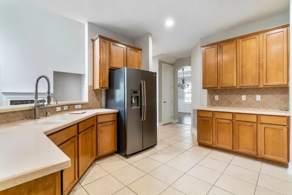 a kitchen with stainless steel appliances granite countertop a refrigerator and a sink