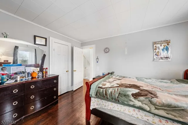 a bedroom with a bed and a dresser in it