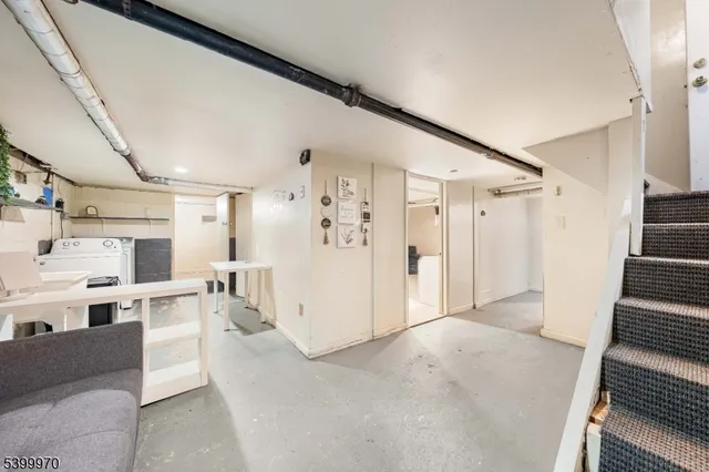 a view of kitchen with furniture and refrigerator