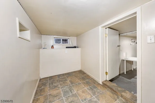 a view of a kitchen with a sink and a refrigerator