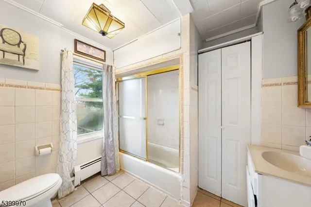 a bathroom with a granite countertop sink a toilet and shower