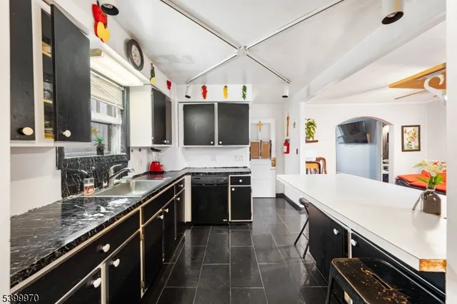 a kitchen with lots of counter top space and stainless steel appliances