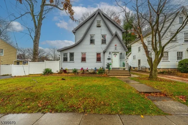 a front view of house with yard and trees