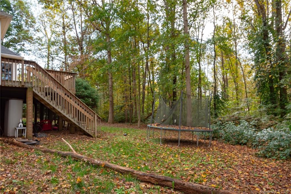 3217 Weidner Road Newton, NC 28658 - Photo 8 of 43 a view of a house with large trees and wooden fence