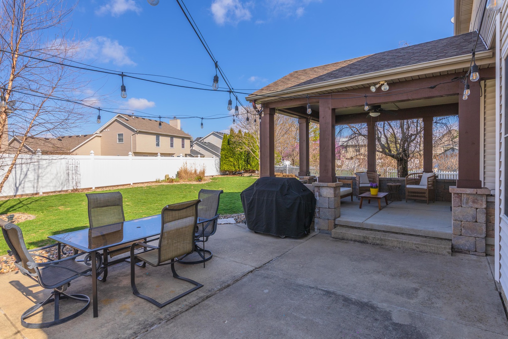 1223 Joy Walk Way Normal, IL 61761 - Photo 42 of 48 a view of a patio with table and chairs potted plants with wooden floor