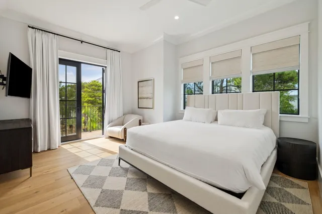 a bedroom with a large bed and a flat tv screen
