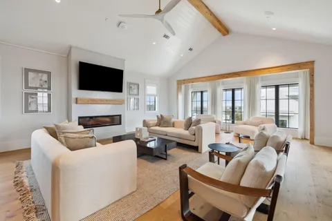 a living room with furniture fireplace and a flat screen tv