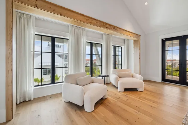 a spacious bedroom with a bed and large windows