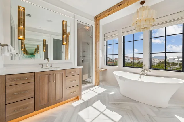 a spacious bathroom with a tub sink and mirror