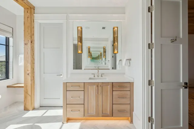 a bathroom with a granite countertop sink a mirror and a bathtub