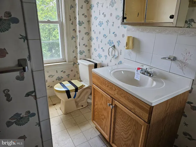 a bathroom with a sink toilet and tub