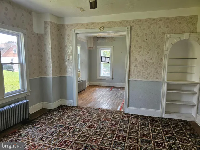 a bathroom with a glass door shower and a window
