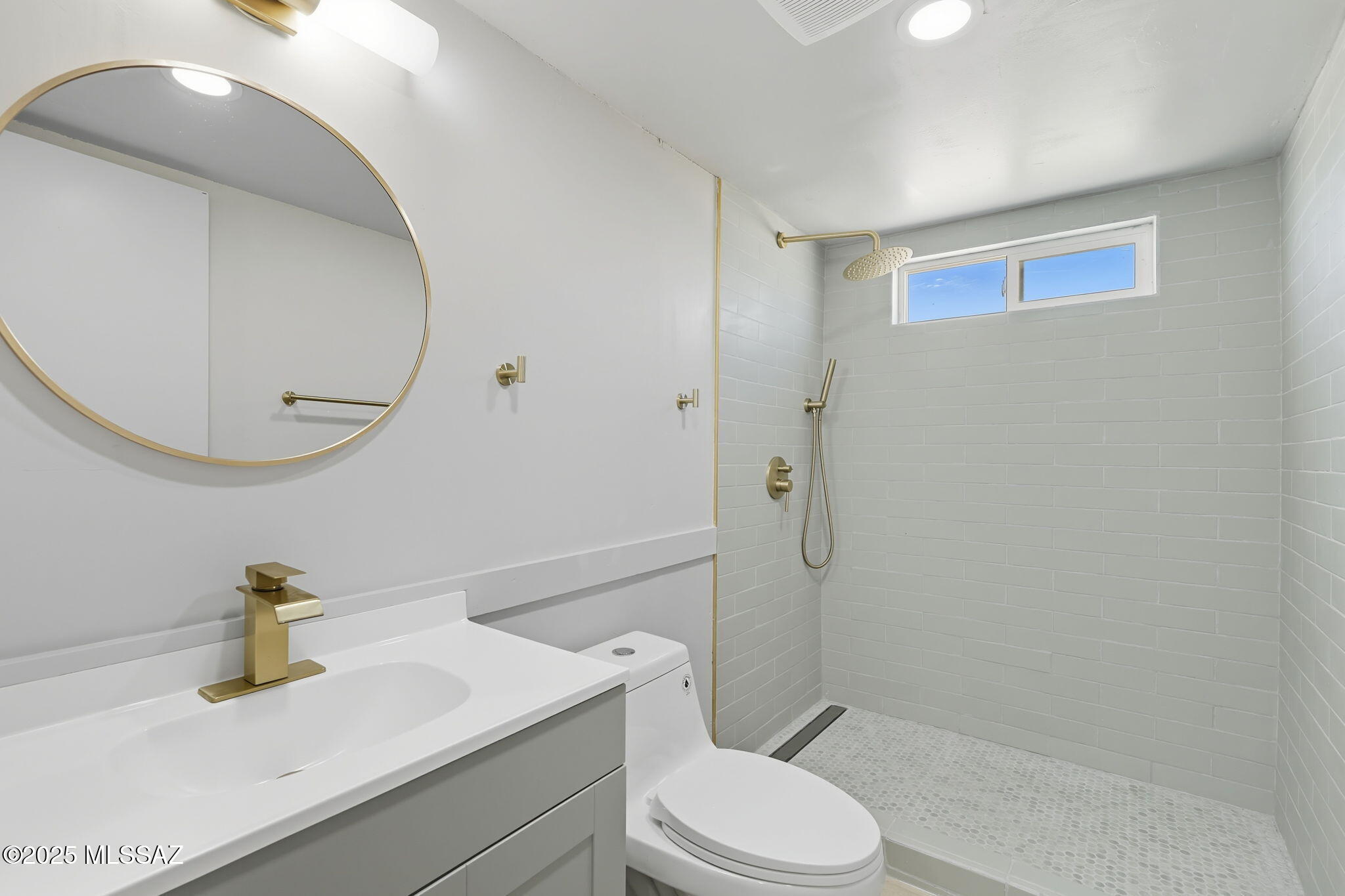 8790 North Trico Road Marana, AZ 85653 - Photo 22 of 35 a bathroom with a sink a toilet and a mirror