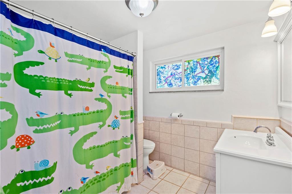 1147 Thomas Eighty Four Road Eighty Four, PA 15330 - Photo 15 of 24 a bathroom with a sink mirror and toilet