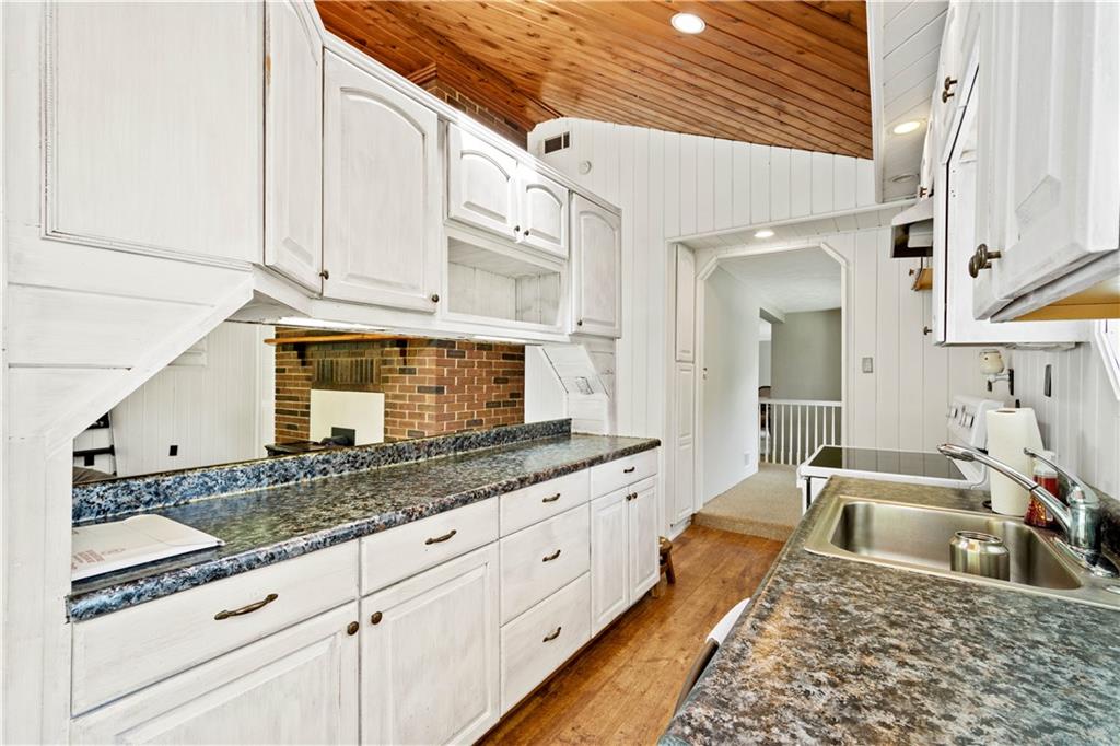 1147 Thomas Eighty Four Road Eighty Four, PA 15330 - Photo 7 of 24 a kitchen with granite countertop a sink and cabinets
