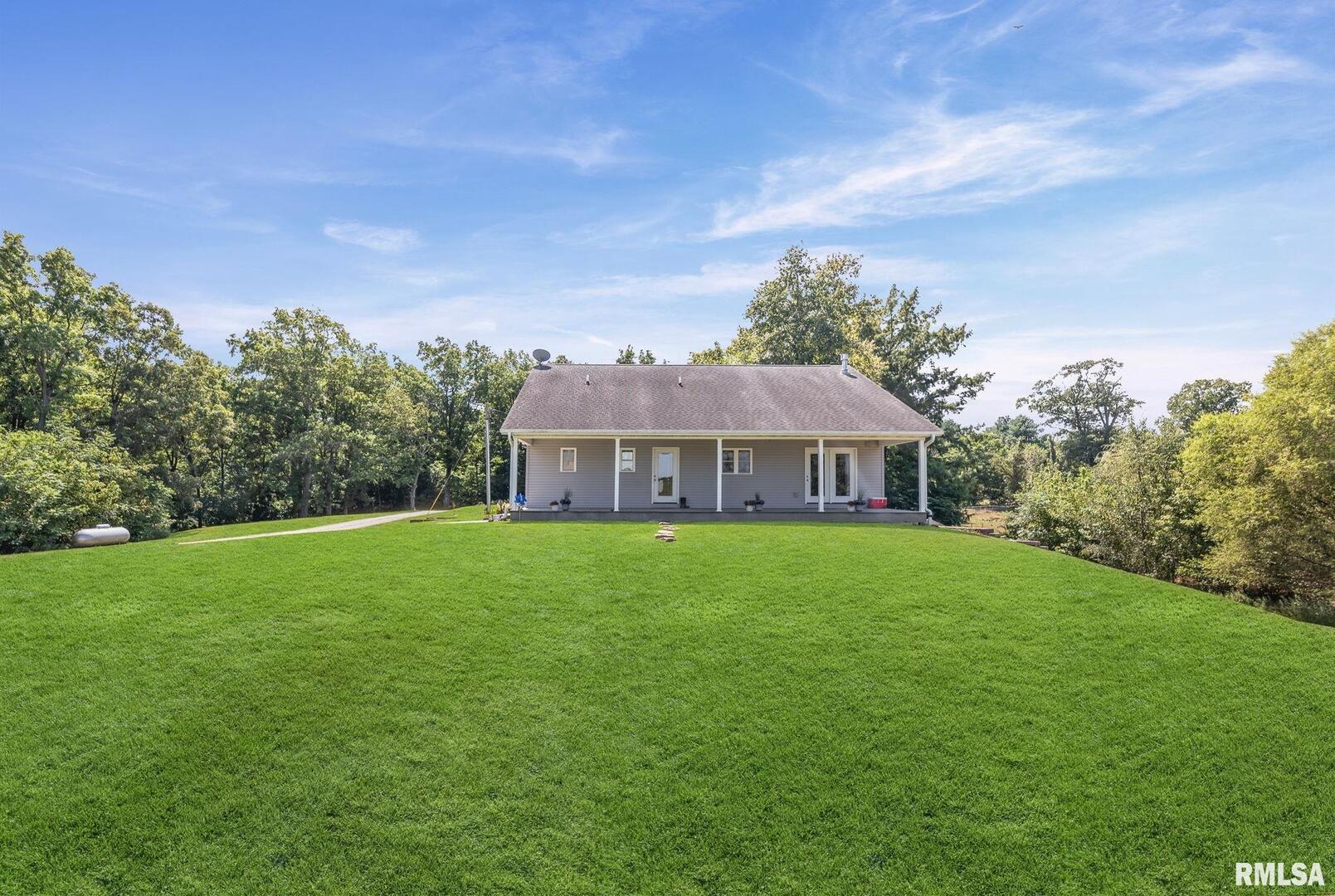 520 Deerfield Road Walnut Hill, IL 62893 - Photo 2 of 85 a view of a house with a big yard potted plants and large tree