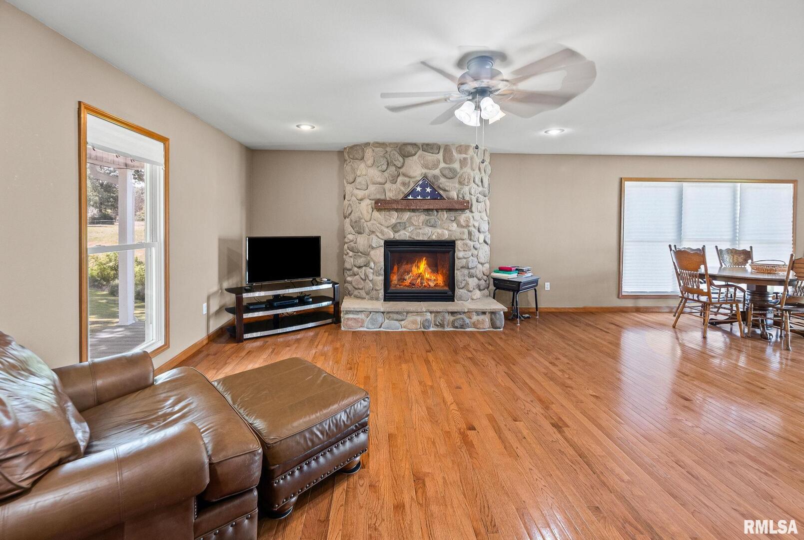 520 Deerfield Road Walnut Hill, IL 62893 - Photo 35 of 85 a living room with furniture a fireplace and a flat screen tv