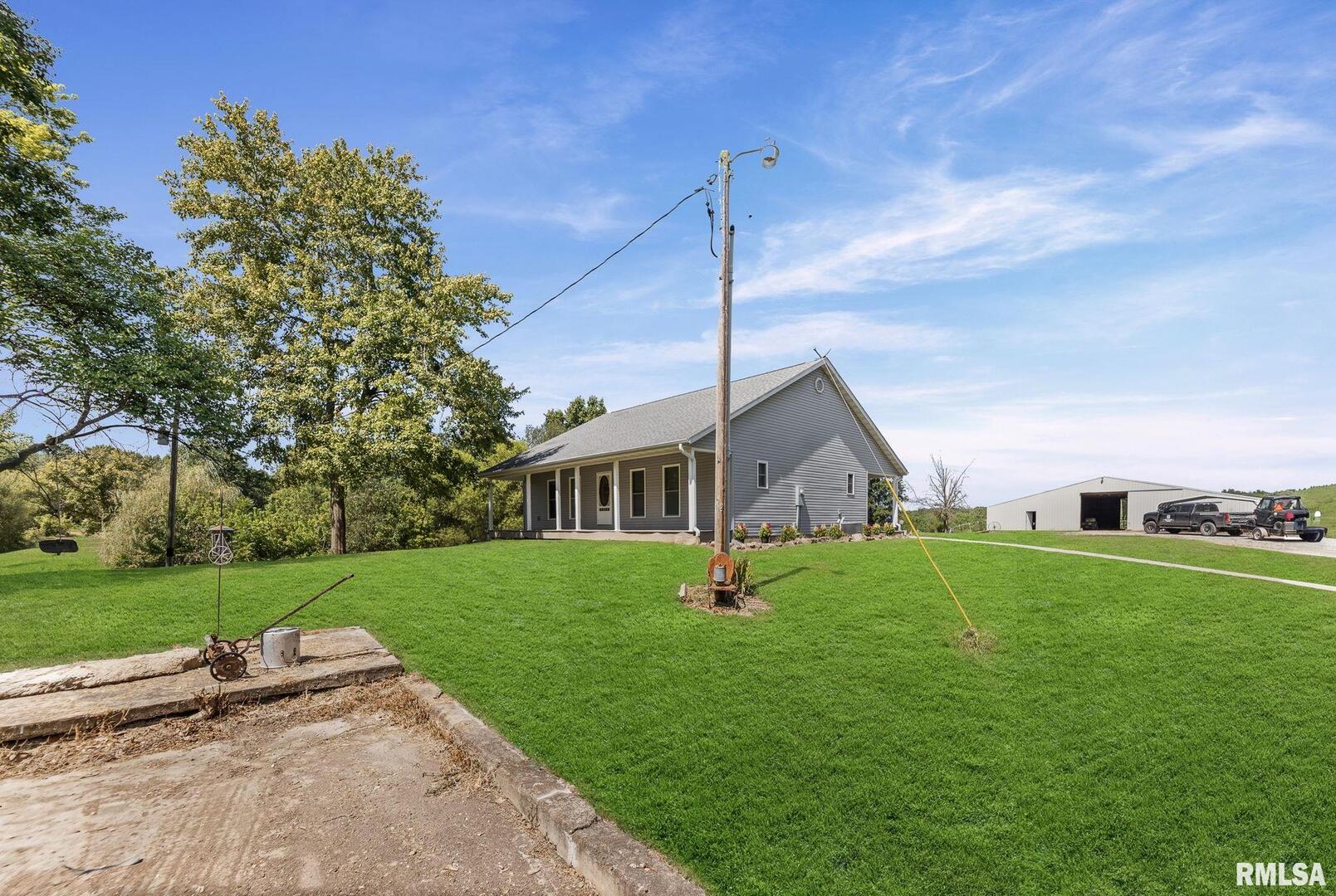 520 Deerfield Road Walnut Hill, IL 62893 - Photo 5 of 85 a front view of a house with a garden and yard