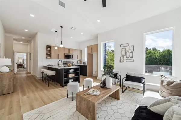 a living room with furniture and kitchen view