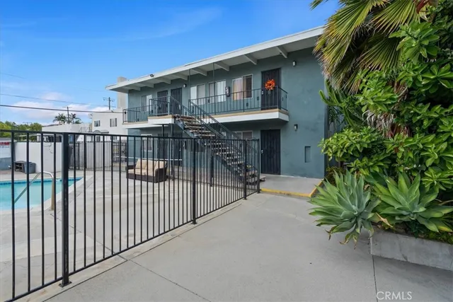 a view of a house with a small yard and plants
