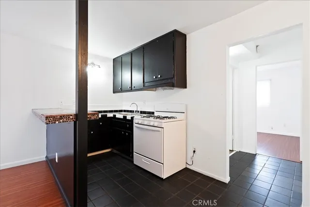 a kitchen with a stove and a refrigerator