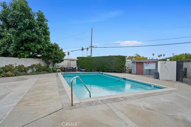 a view of a swimming pool with a yard