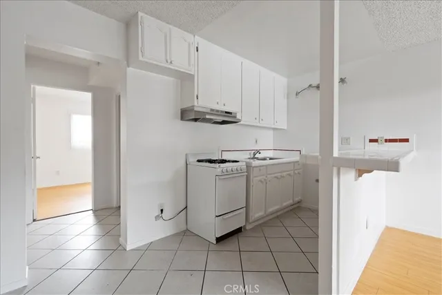 a kitchen with cabinets and appliances