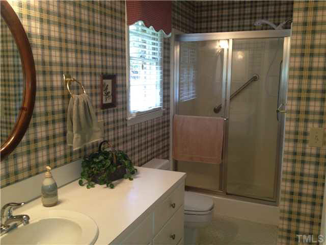 859 Old Salem Road Roxboro, NC 27573 - Photo 22 of 25 a bathroom with a sink a toilet and shower