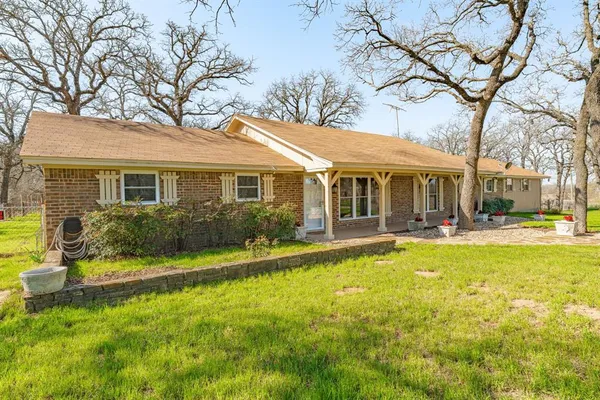 a front view of a house with swimming pool and porch