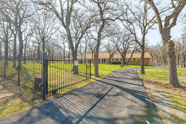 a view of a park with iron fence