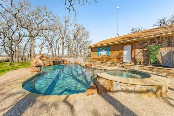 a view of a swimming pool with a patio