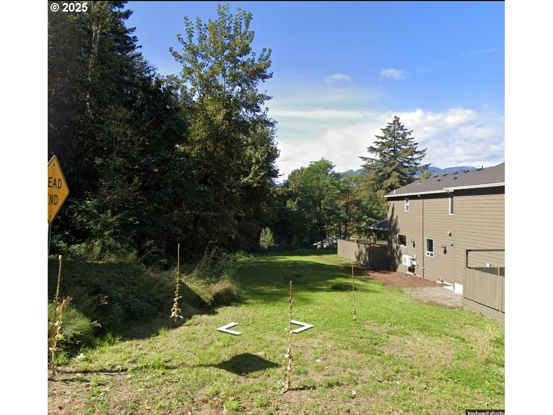 725 Southwest Moody Avenue Cascade Locks, OR 97014 - Photo 3 of 7 a backyard of a house with lots of green space