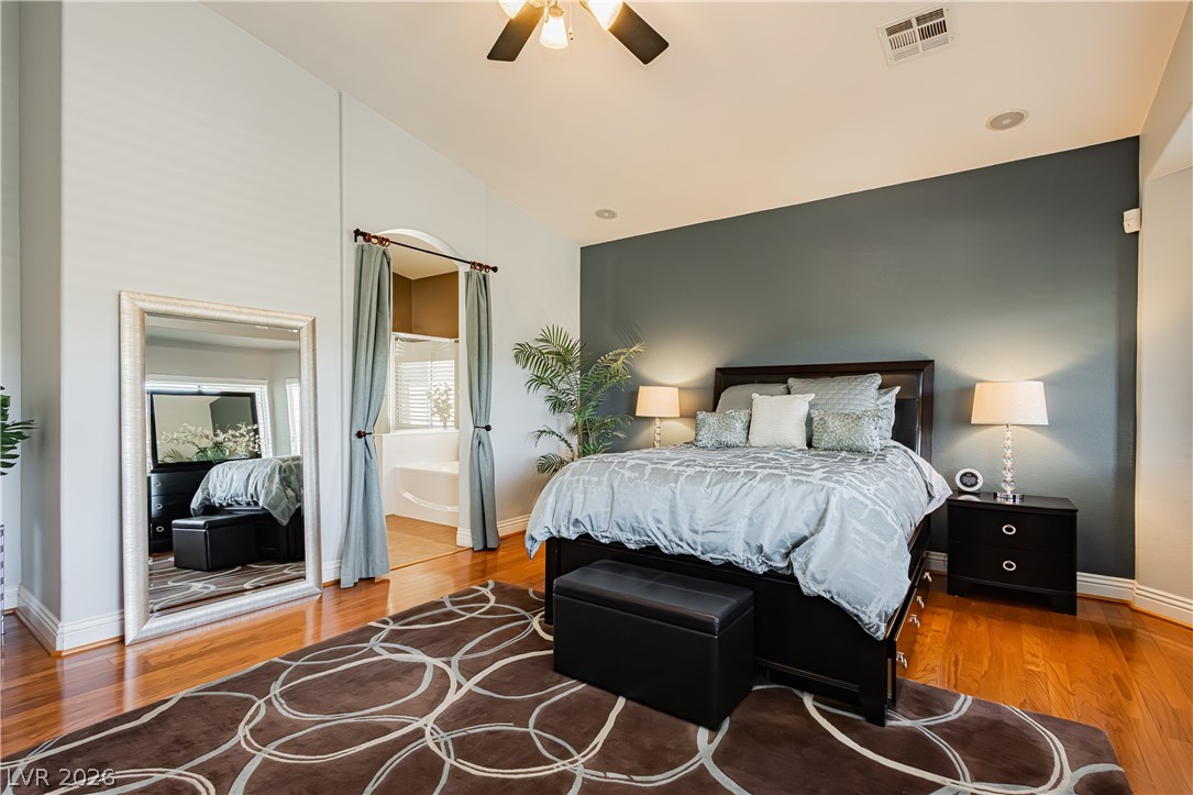 2256 Dogwood Ranch Avenue Henderson, NV 89052 - Photo 36 of 51 Hardwood floors and a spacious layout distinguish this inviting primary bedroom suite.