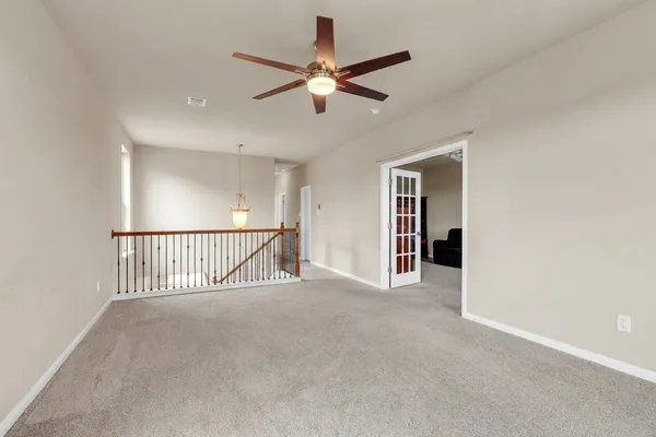 a view of a hallway with a ceiling fan