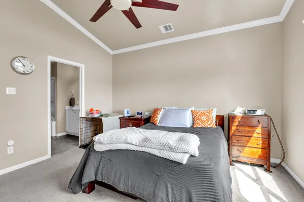 a bedroom with a bed and ceiling fan