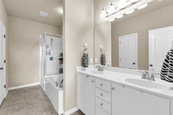 a spacious bathroom with a double vanity sink mirror and double
