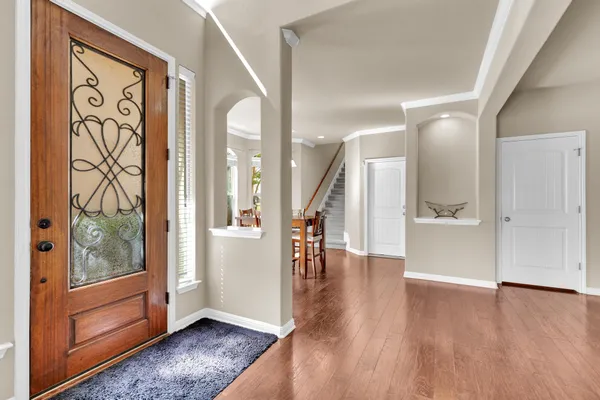 a view of an entryway with wooden floor