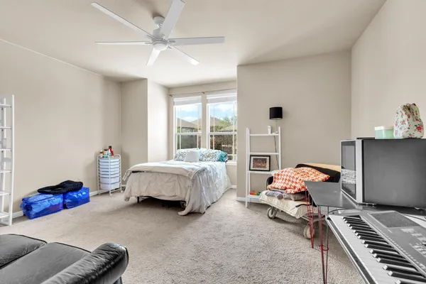 a bedroom with furniture and a window