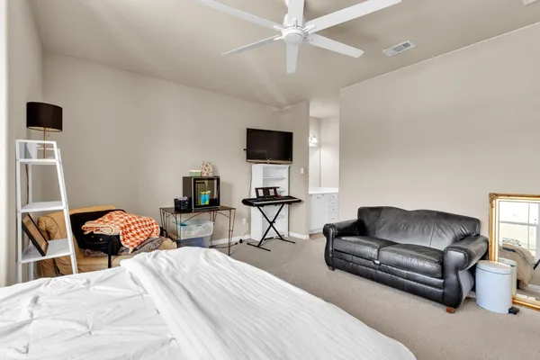 a bedroom with a bed and a couch