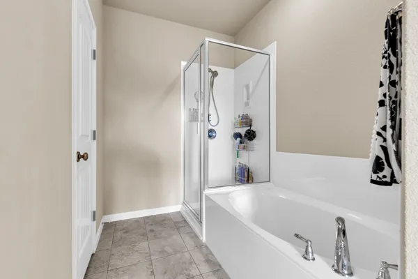 a bathroom with a bathtub and a shower