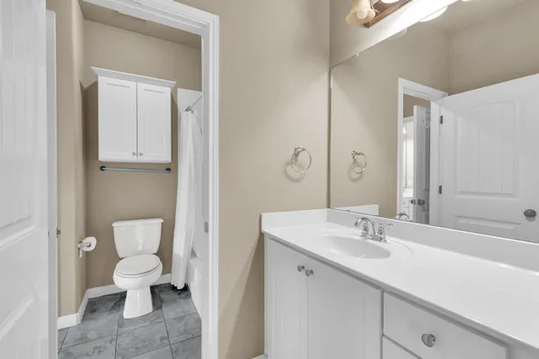 a bathroom with a sink toilet and a mirror