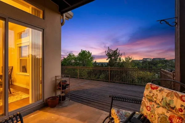 a view of a balcony with chair and wooden floor
