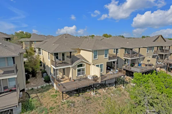 an aerial view of a house with a yard balcony and furniture