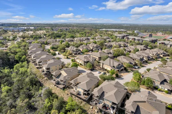 an aerial view of residential building with green space