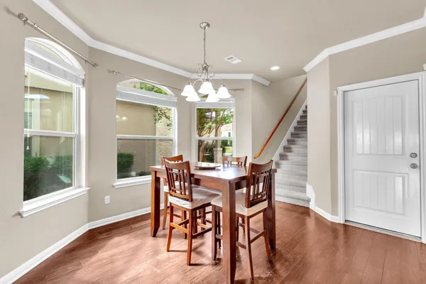 a view of a dining room with furniture window and wooden floor